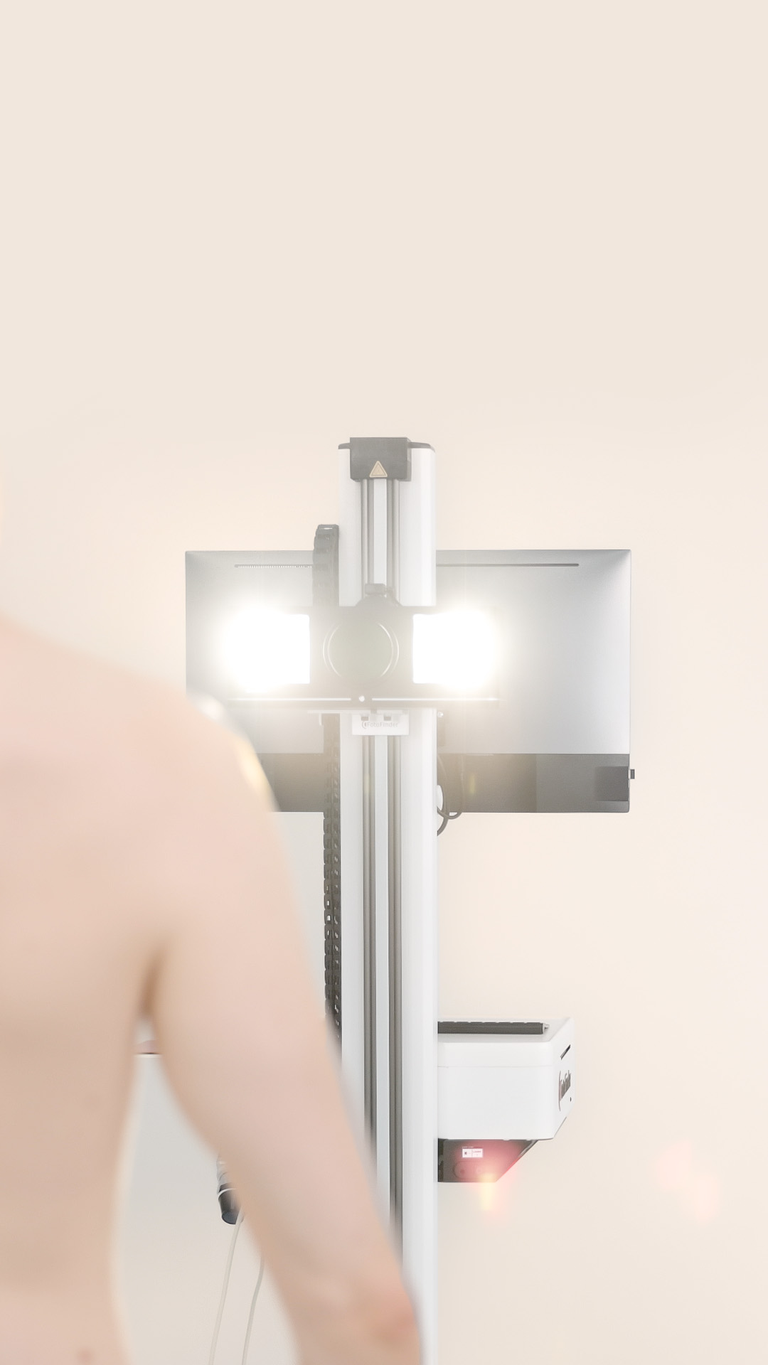 Automated total body mapping: Flash is triggered to photograph the patient’s upper body.